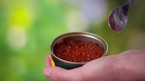 Woman's hand take red caviar from jar by spoon Stock Footage 82994088