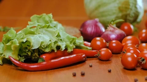 A woman's hand takes cherry tomatoes from the table. Stock Footage 75959333