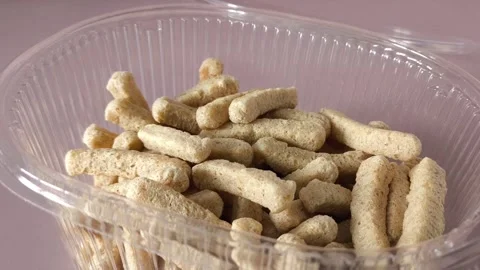 A womans hand takes crispbread from a plastic container with crispbread. Whole Stock Footage 324769988