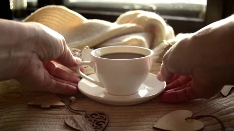 Womans hand takes a mug of black coffee warm scarf with wooden Christmas toys. Stock Footage 220059142