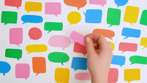 A woman's hand takes a pink speech bubble Stock Footage 301864633