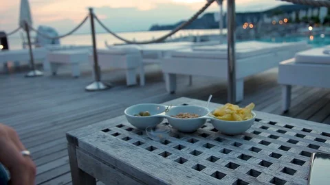 Woman's hand takes snacks at pool bar Stock Footage 96347321