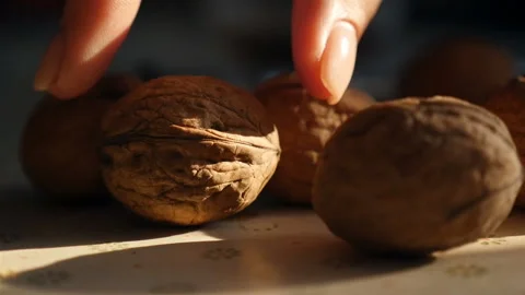 A woman's hand takes a walnut. Close-up. Slow motion Stock-Footage 168356466