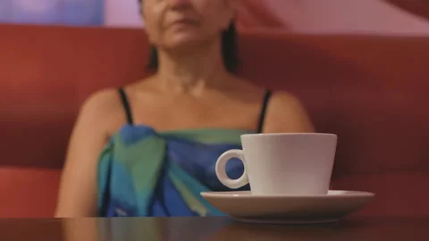 Woman's hand takes a white cup of coffee from the table Stock Footage 120759258