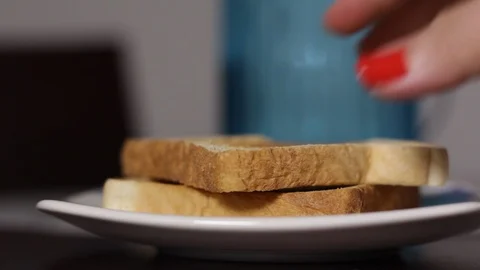 Womans hand taking bread slice and putting it back bited Stock Footage 90095906