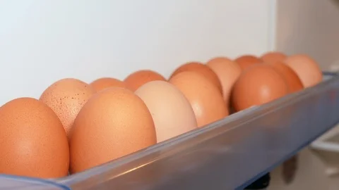 Woman's hand taking egg from fridge Stock Footage 108563293