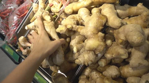 Woman's hand taking ginger at shopping center market slow motion HD Stockbeeldmateriaal 65821283