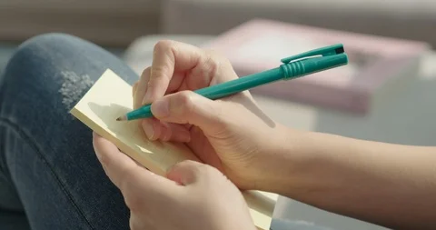 Woman's hand taking notes, close-up Stock Footage 100942553