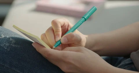 Woman's hand taking notes, close-up Stock Footage 100947399