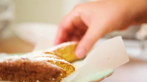 Woman's hand taking a slice of orange cake Stock Footage 76198258