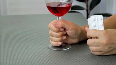 A woman's hand taps on the table thoughtfully, about to poison herself with pill Stock Footage 221925268