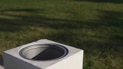 The woman's hand throws a cup of coffee in the trash against the backdrop of a Stock Footage 127101819