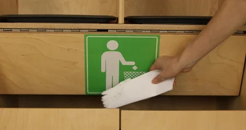 Womans hand throws paper debris into trash Stock Footage 89840435