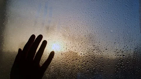 Woman's hand touches the cold and wet window pane. Stock-Footage 258091256