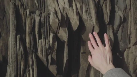 A woman's hand touches a rock Stock Footage