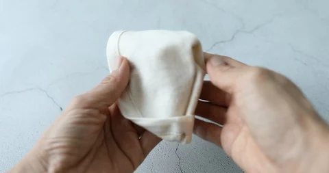 Woman's hand touching surface of flannel filter and feeling it's texture Stock Footage 117692735