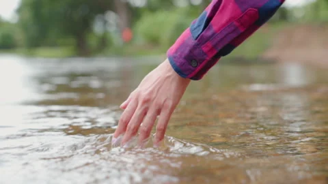 A woman's hand touching the surface of river she feeling relaxed. Stock Footage 254716270