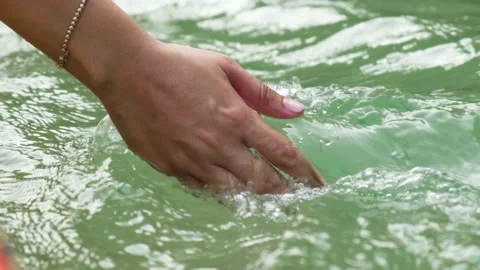 Woman's hand touching the water in a forest river or lake. Sourced from the wate Stock Footage 237139006