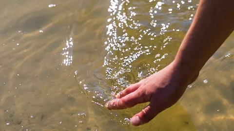 Woman's hand touching water surface. Slow motion HD RAW video Stock Footage 58669336