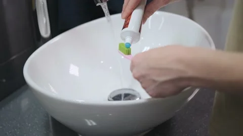 A woman's hand. A tube of toothpaste. Stock Footage 150974775