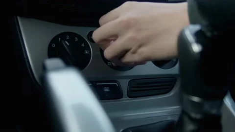 Woman's hand turn on maximum interior heating in the car Video stock 231775675