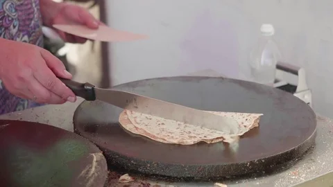 Woman's hand with turner turns baking pancake on other side of pancake maker. Stock Footage 78240968