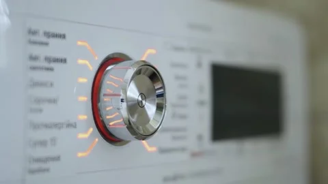 Woman's hand turning on and off the switch of the washing machine Stock Footage 153555710