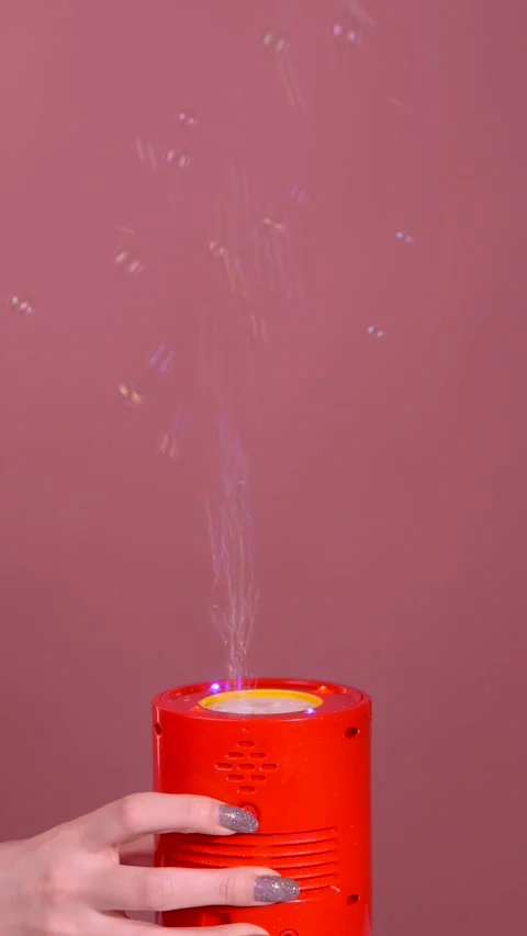 Woman's hand turns on bubble generator, lots of soap bubbles at party Stock Footage 319747416