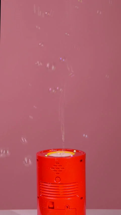 Woman's hand turns on bubble generator, lots of soap bubbles at party Stock Footage 319747664