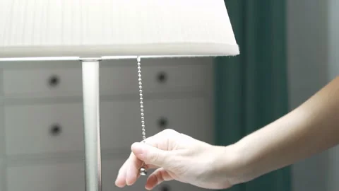 A Woman's Hand Turns Off The Lamp, The Light Goes Out. The Hand Pulls the String Video stock 159058958