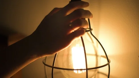 Womans hand turns light on 스톡 동영상 91583277