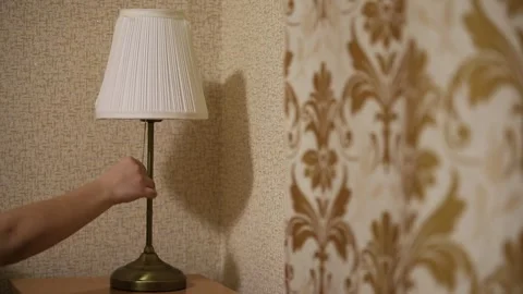 A Woman's Hand Turns on The Light. The Process Of Turning on The Table Lamp Stock Footage 313504229