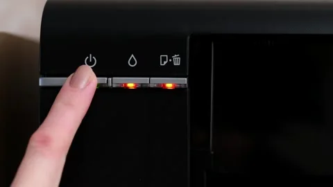 A woman's hand turns on the printer, all indicators are on, the printer is Stock Footage 241354747