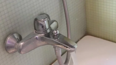 Woman's hand turns running bath tap off in bathroom Stock Footage 42132872