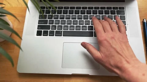 A woman's hand types on a laptop keyboard. Top view Stock Footage 234065710