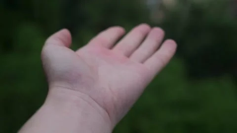 Woman's hand under heavy rain, raindrops falling on hand during stormy weather. Stock Footage 277643286