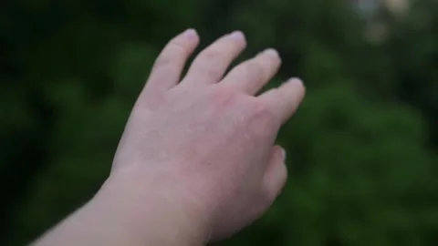 Woman's hand under heavy rain, raindrops falling on hand during stormy weather. Stock Footage 277643293