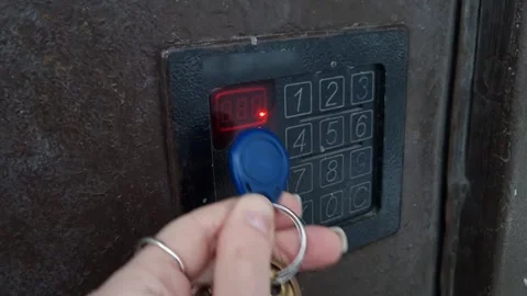 Womans Hand Unlocking Intercom Door with Electronic Key Fob Stock Footage 326359727
