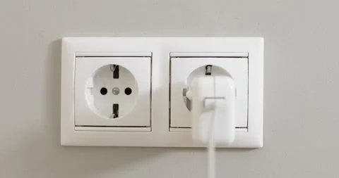 Woman's hand unplugging white power plug into white multiple socket indoors. Stock Footage 156804678