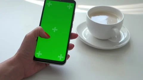 Woman's hand use green screen smartphone for online shopping at the cafe table Stock Footage 161615702