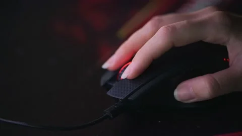 Woman's hand uses computer mouse in the evening, turns the wheel Stock Footage 154115229
