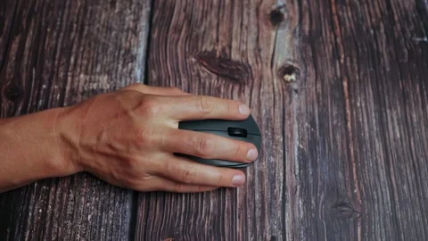 A woman's hand uses a computer mouse to operate, presses buttons, close-up. Stock Footage 243291019