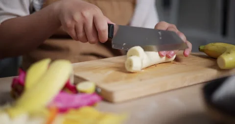 Woman's hand using knife to cut bananas to prepare to make dessert 스톡 동영상 308219801