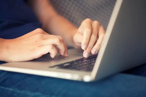 Woman's hand using laptop Stock Photos