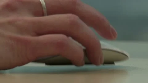 Woman's hand using a mouse and drags it off screen Stock Footage 12366502