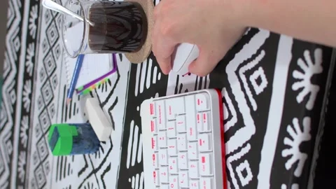 Woman's hand using mouse next to a white keyboard, notepad on white desk. Stock Footage 138544212