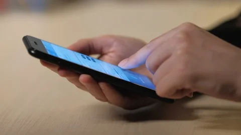 Woman's hand using a smartphone Stock Footage 104772609