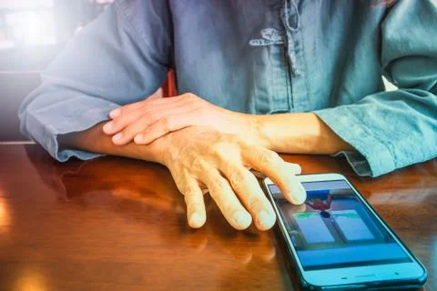 A woman's hand using a smartphone on the table, Backgrounds Stock Photos