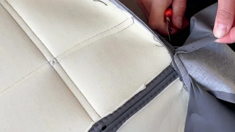 Woman's hand using a Snap-Off knife cutting up chair upholstery for restore Stock-Footage 203945463