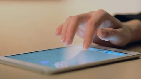 Woman's hand using a tablet Stock Footage 104772552